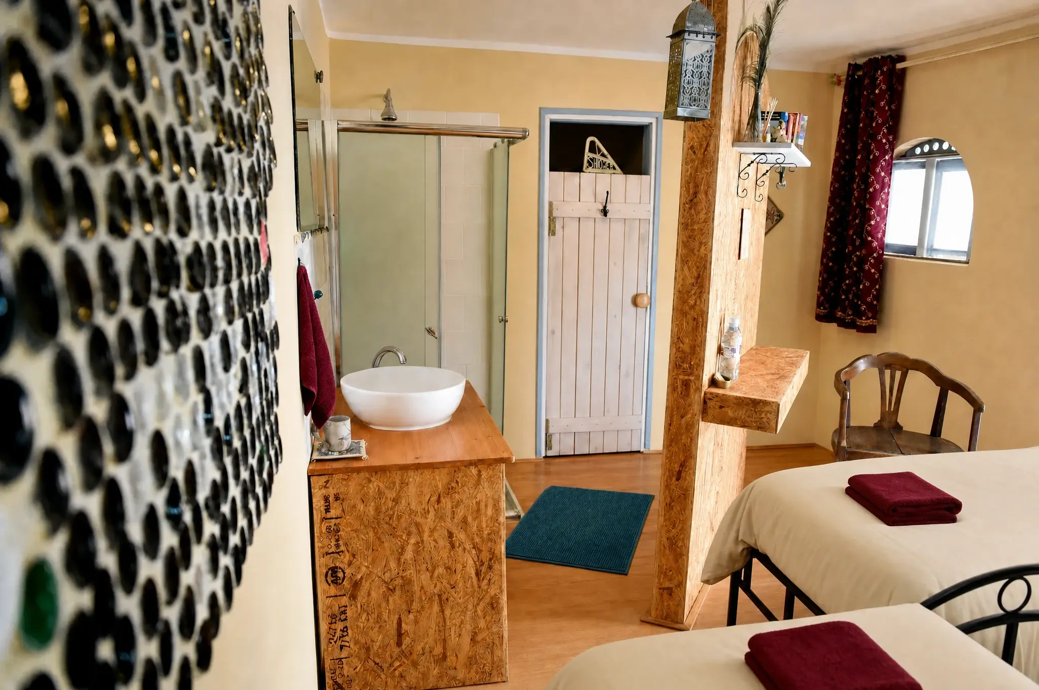 A bathroom with a glass-bottle wall