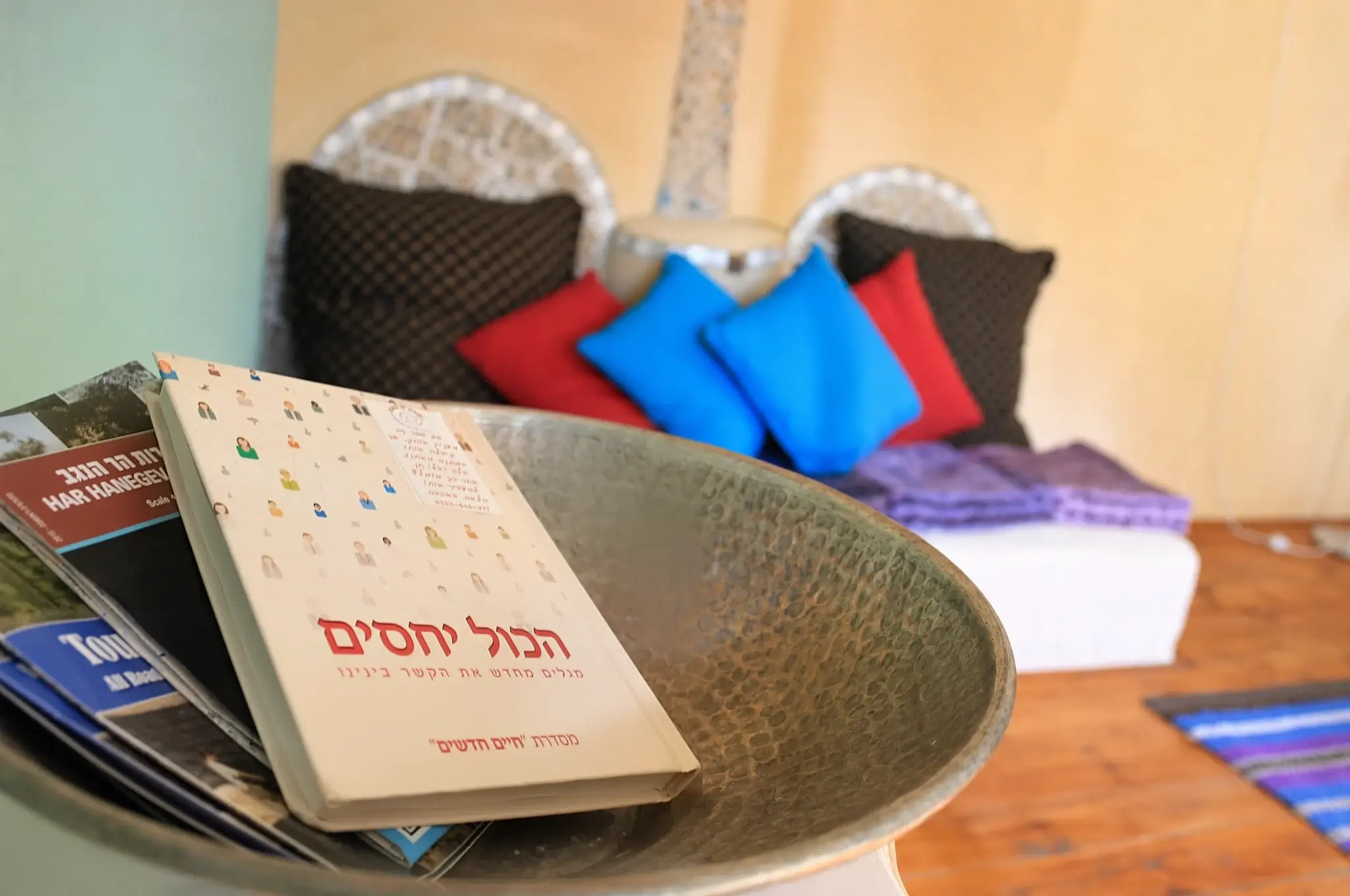 A book and colorful cushions in a sitting corner