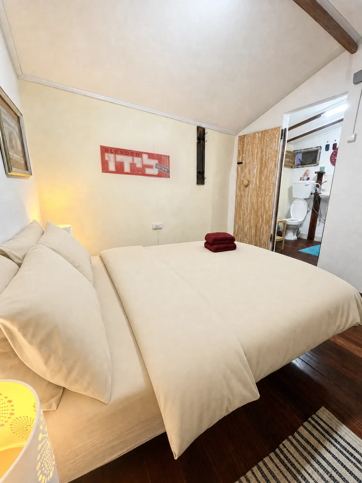 The Eden bed, the old “Lido” sign and the open bathroom door