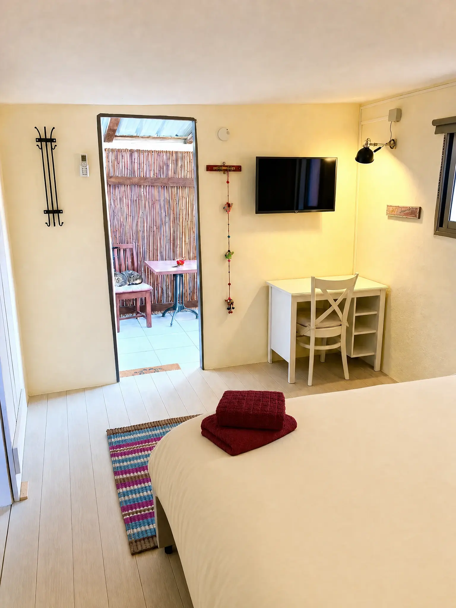The Raz room: a TV, a desk and the door open to the patio