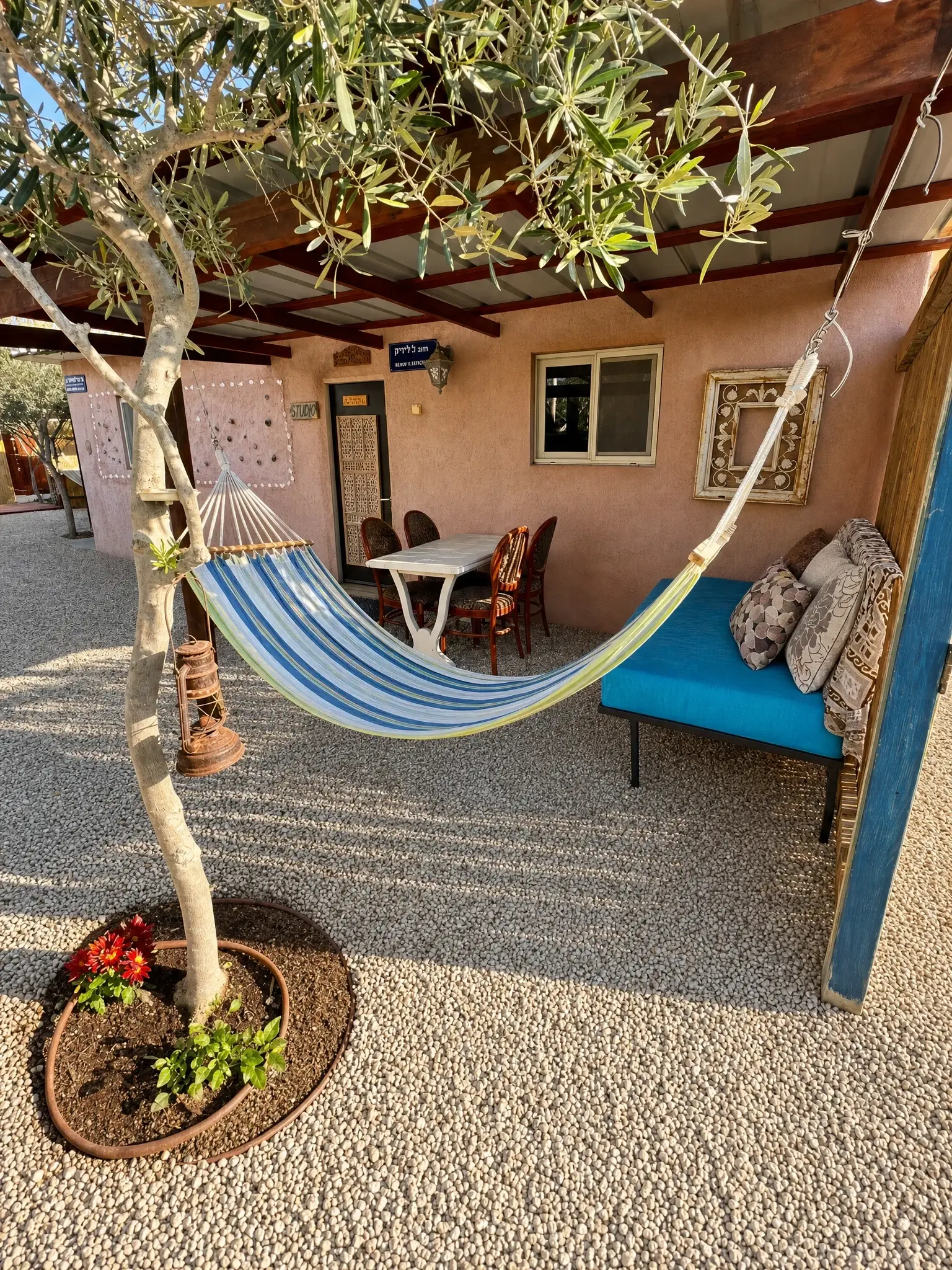 Outside the Studio: an olive tree, a hammock and a sitting area