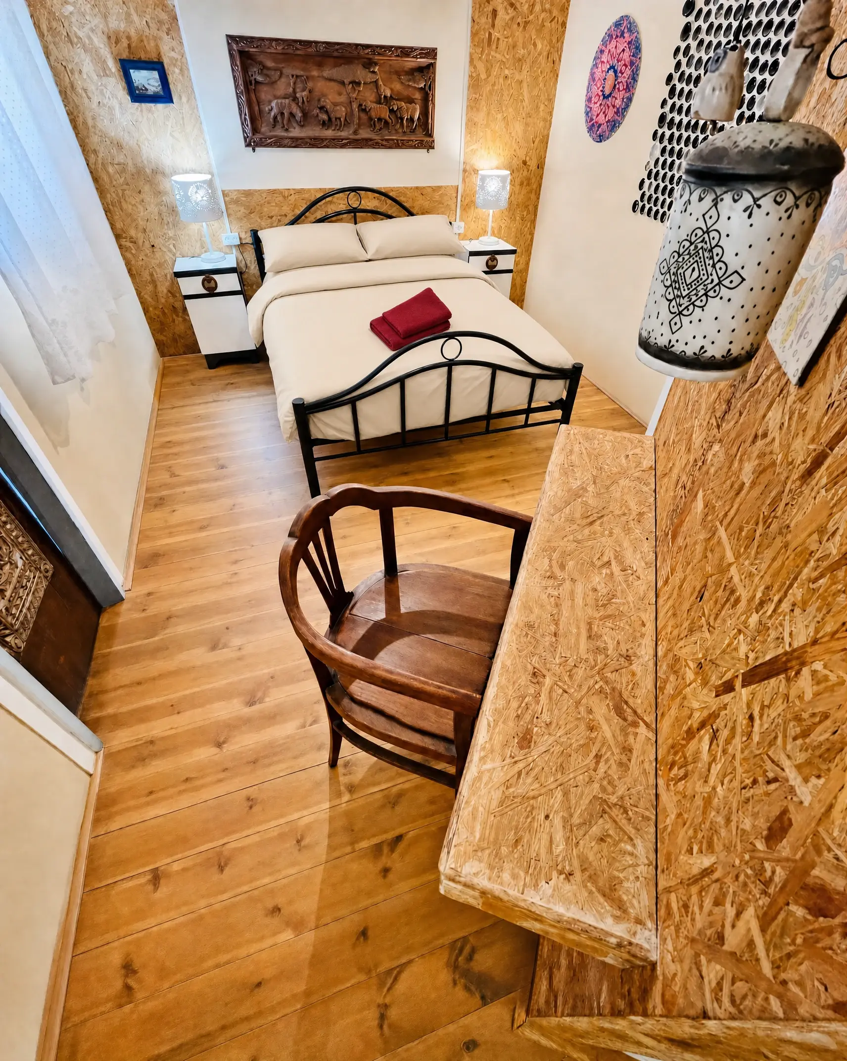 The Vintage room from the door: a wooden floor, a wooden chair and the double bed