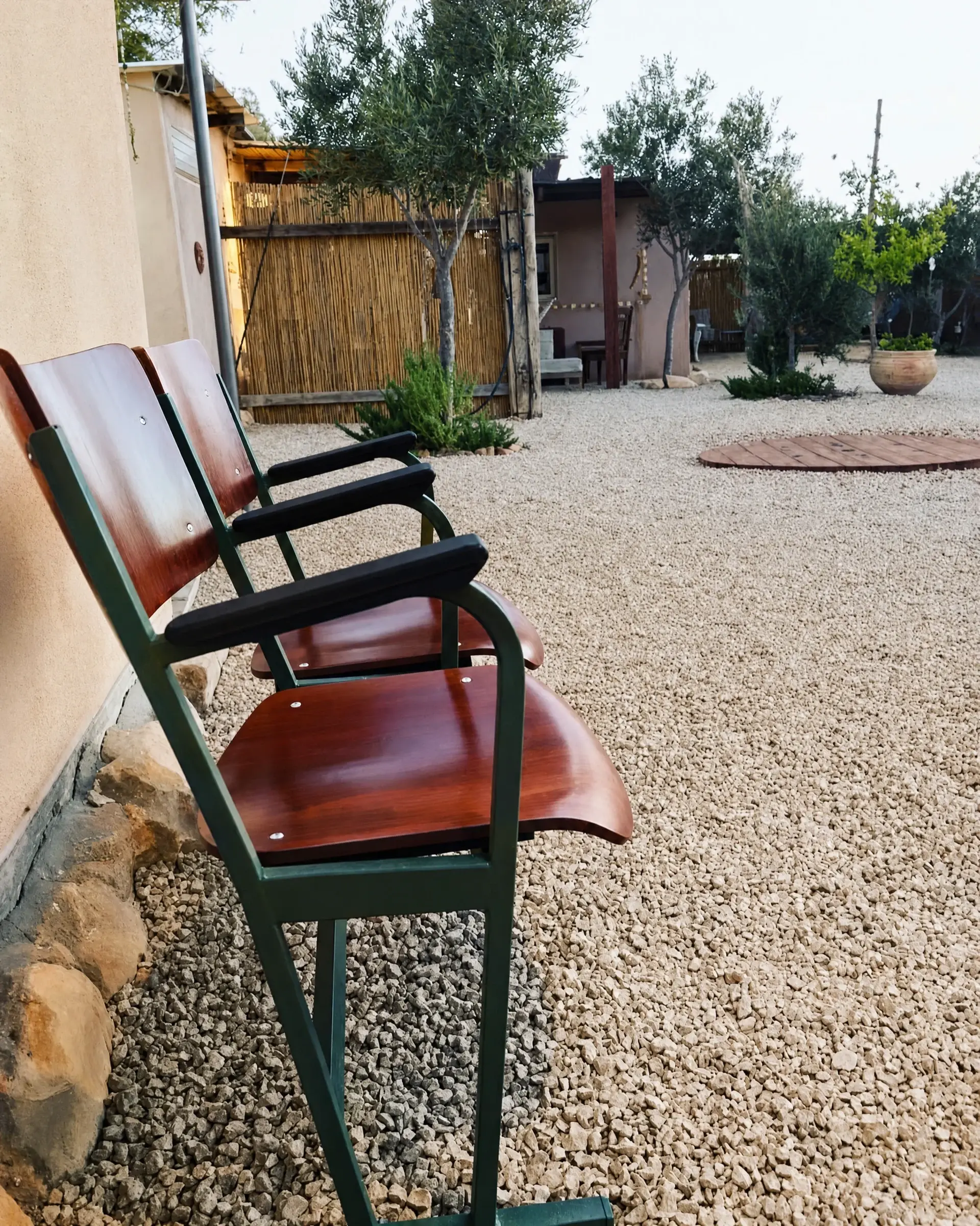 Red chairs on the gravel yard
