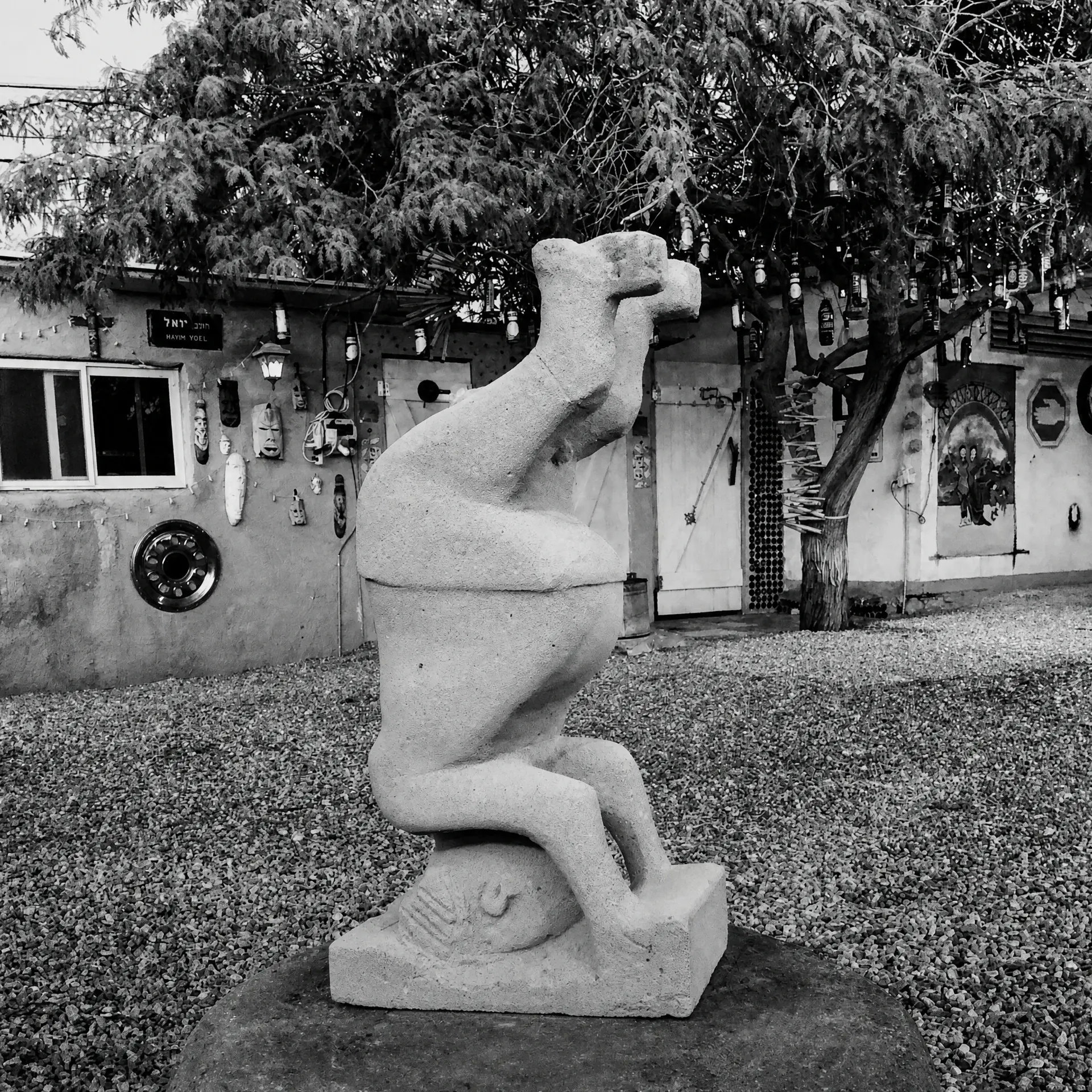 A stone sculpture in the yard, in black and white